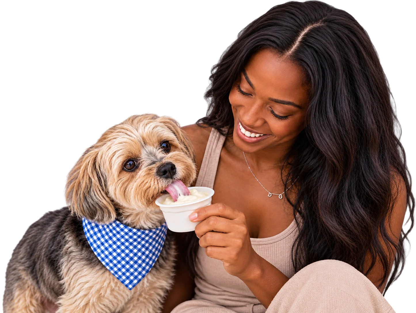 Woman feeding YowUp Frozen Yogurt to a happy dog